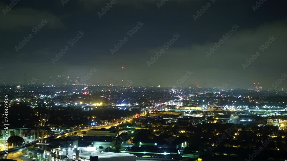 Aerial Panning Shot Of Fireworks Exploring Over Houses In City At Night - Los Angeles, California Aerial Panning Shot Of Fireworks Exploring Over Houses In City At Night - Los Angeles, California