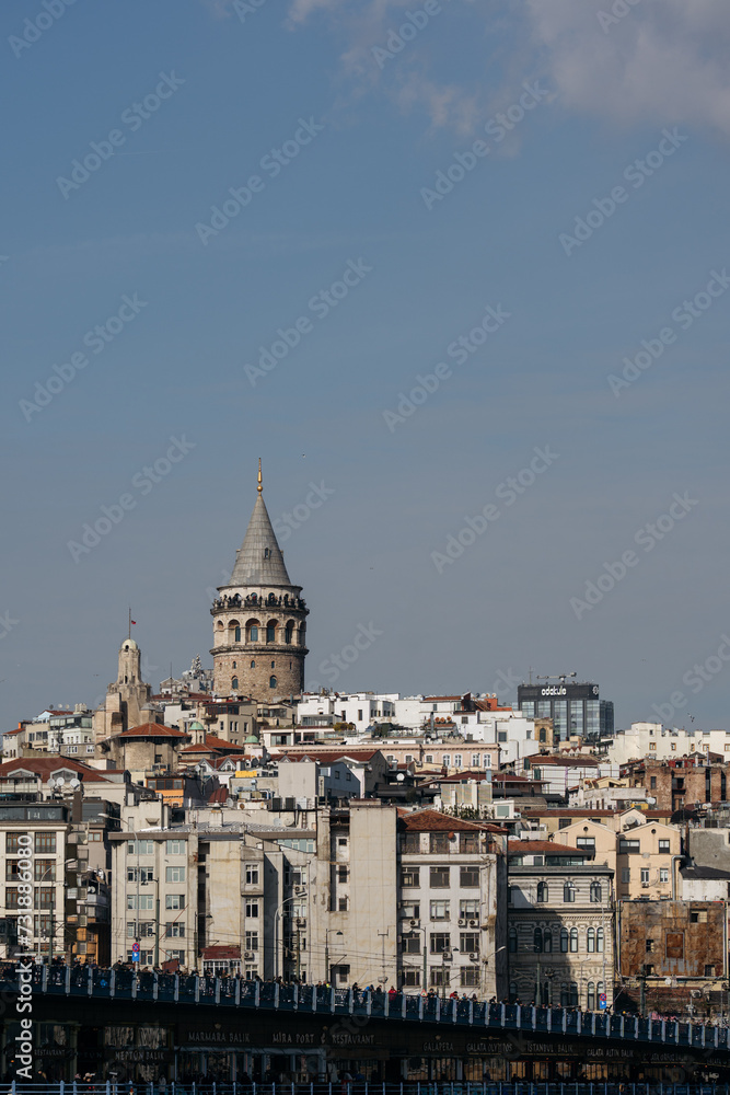 Galata Tower standing tall above Istanbul's cityscape on a sunny day.