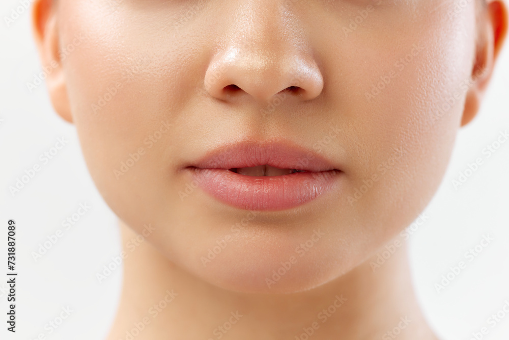 Close-up of lower face with focus on natural lips, clear skin and nose. Lip products ads. Skin clinic for treatments offering smooth, clear skin and healthy lips. Concept of skincare, cosmetology Close-up of lower face with focus on natural lips, clear skin and nose. Lip products ads. Skin clinic for treatments offering smooth, clear skin and healthy lips. Concept of skincare, cosmetology