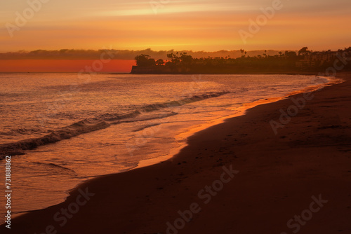 A Colorful Ocean Sunset Sky as a Gentle Wave Rolls in Santa Barbara Harbor Marina Ships Bay California,