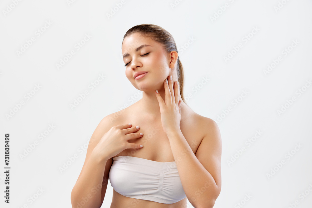 Portrait of beautiful young woman with smooth, clear, spotless skin and nude makeup posing against white studio background. Concept of beauty, skincare, cosmetics and cosmetology Portrait of beautiful young woman with smooth, clear, spotless skin and nude makeup posing against white studio background. Concept of beauty, skincare, cosmetics and cosmetology