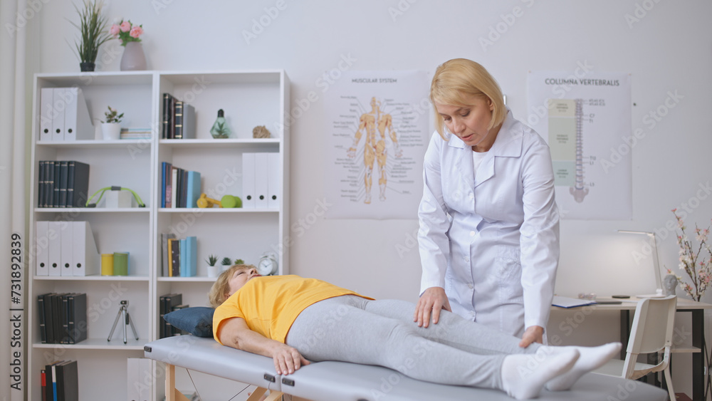 A female orthopedist assesses a patient in a clinic, treating joint pain, and providing healthcare