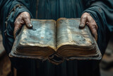 Person holding an open old Bible