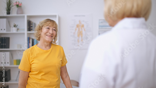 A senior patient and a doctor share a smile, reflecting on a successful treatment