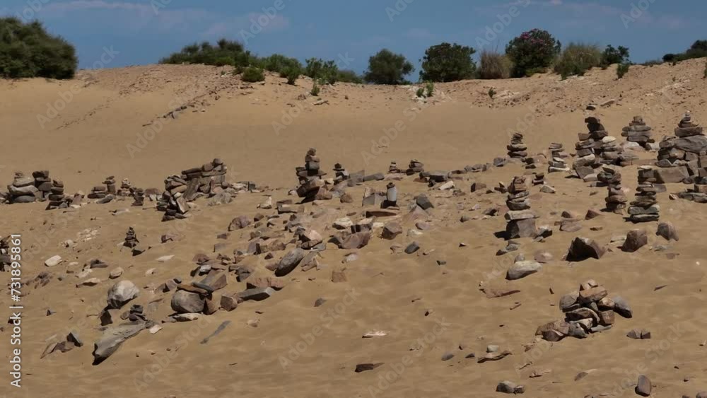 Drone view of rocks on a sandy hill with a background of a lake Drone view of rocks on a sandy hill with a background of a lake
