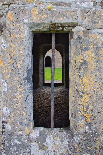 View through window and doors of the ruins of Rosserk friary in County Mayo, Ireland photo