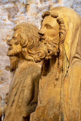 VALENCIA, SPAIN - FEBRUARY 14, 2022: The detail of statue of apostle from Puerta de los Apostloles gate in the Cathedral by Nocolas de Autun from first part of 14. cent.. photo