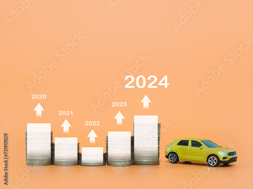 Toy cars, Stack of coins with virtaul increasing graph, arrow rising. The concept for price of car, car loan, insurance, paying tax in year 2024 photo