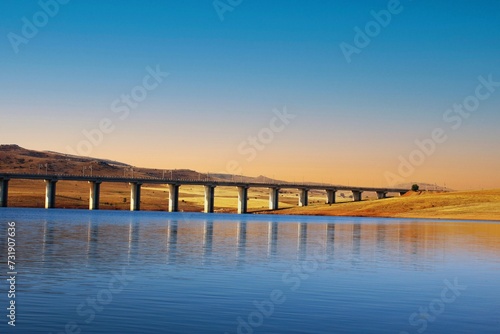 Fototapeta Naklejka Na Ścianę i Meble -  Concrete railroad bridge in the lake. fantastic sunset. Yozgat,Sorgun . 