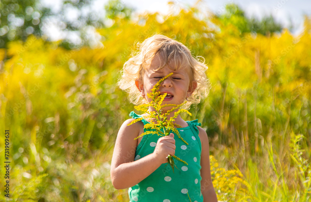 A child is allergic to ragweed blooming in the park. Selective focus. A child is allergic to ragweed blooming in the park. Selective focus.