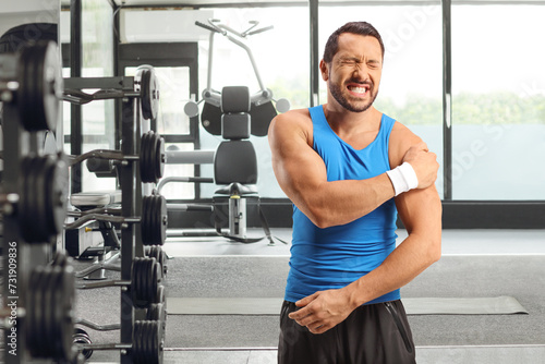 Man at the gym with injury on his shoulder