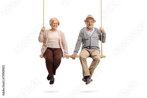 Elderly man and woman sitting on a wooden swing