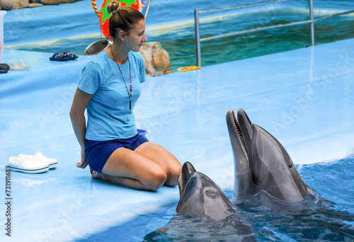 girl, trainer with  dolphins.
