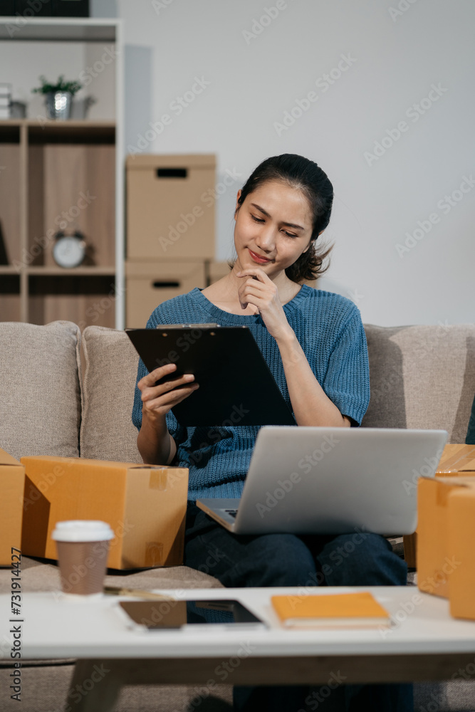 Business woman using laptop computer in office. Happy woman, entrepreneur, small business owner working online. Business woman using laptop computer in office. Happy woman, entrepreneur, small business owner working online.