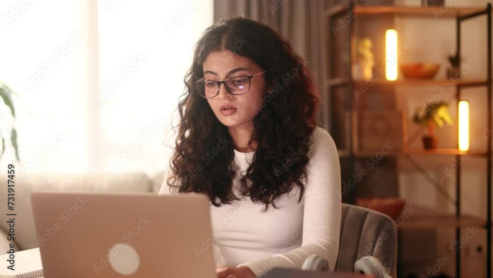 Tired young curly woman feels satisfied with distance remote work well done at home Calm self employee female relax after hard working day finished project on laptop computer indoors Tired young curly woman feels satisfied with distance remote work well done at home Calm self employee female relax after hard working day finished project on laptop computer indoors