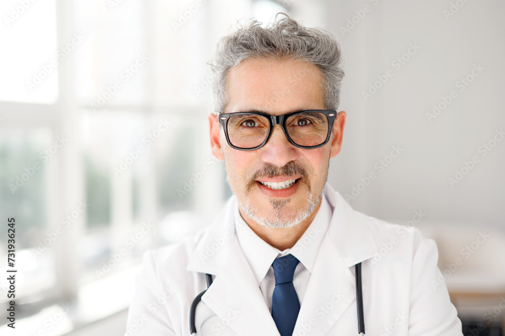 A portrait of a senior doctor with a warm smile, wearing glasses and a stethoscope, captured in a well-lit office that communicates a welcoming and professional healthcare setting. Healthcare concept A portrait of a senior doctor with a warm smile, wearing glasses and a stethoscope, captured in a well-lit office that communicates a welcoming and professional healthcare setting. Healthcare concept