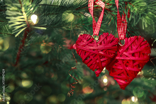 Valentine's Day background with two hanging heart shapes on Christmas tree.