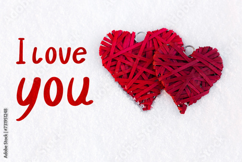 Valentines day background with i love you text and two red hearts on white sn...