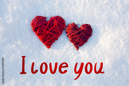 Valentines day background with i love you text and two red hearts on white sn...