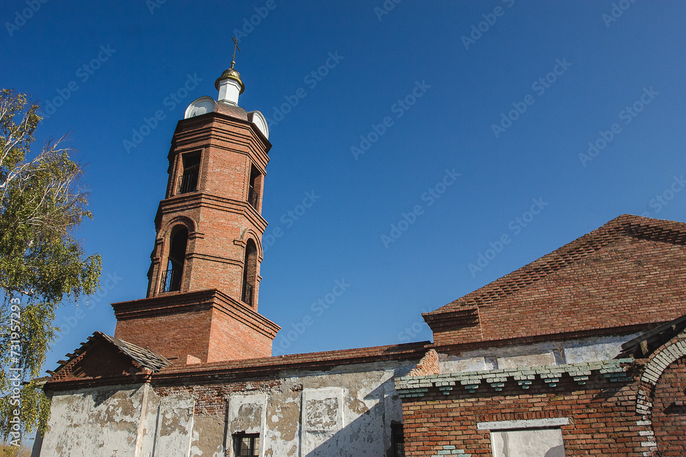 Restored Old Church In Deserted Village In Autumn Colors Under Clear Blue Sky