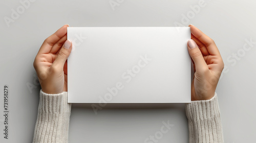 Hands holding blank paper - mockup (ID: 731958279)