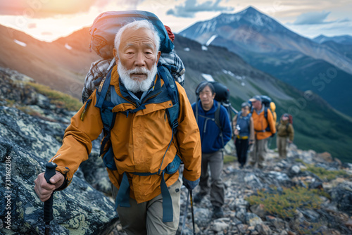 Active pensioners go mountaineering. group of elderly people with backpacks are climbing mountain.