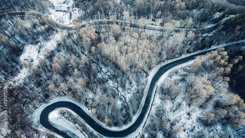 Aerial view of winding mountain road in winter. © Iryna