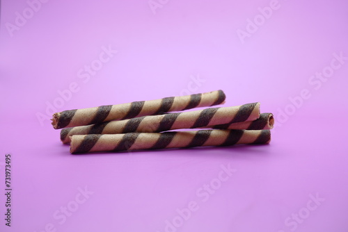 wafer stick isolated purple background. 2 chocolate flavored wafer sticks.