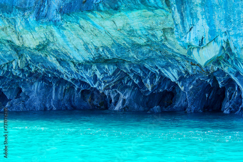 Turquoise water of General Cerrerra Lake splashing against blue Marble caves or Cuevas de Marmol at General Cerrerra Lake. Location Puerto Sanchez, Chile
