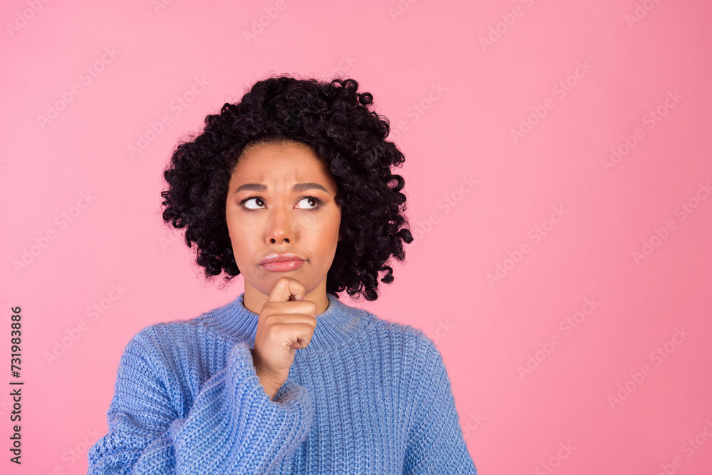 Photo portrait of attractive young woman look unsure moody empty space wear trendy blue knitwear clothes isolated on pink color background Photo portrait of attractive young woman look unsure moody empty space wear trendy blue knitwear clothes isolated on pink color background