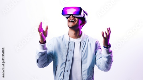 A young man using VR glasses, happy and excited making a winner gesture with arms raised over Isolated on a gray background studio portrait. VR, future, gadgets, technology, neon sty. © inthasone