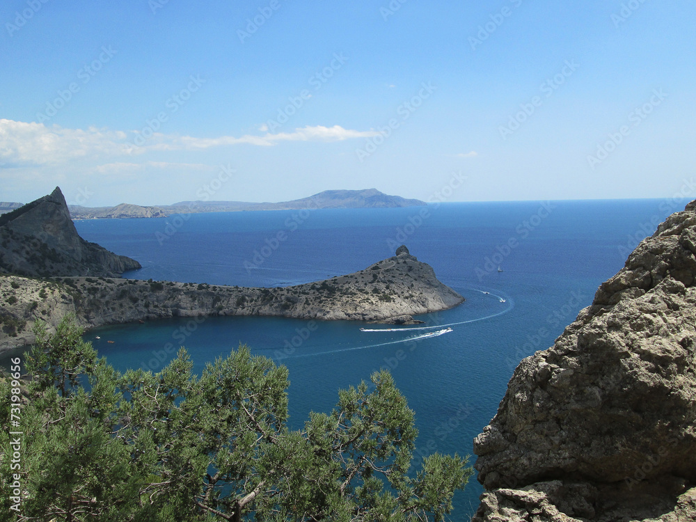 Beautiful view from the mountain to the seashore in the radiance of the blue sky and blue sea.