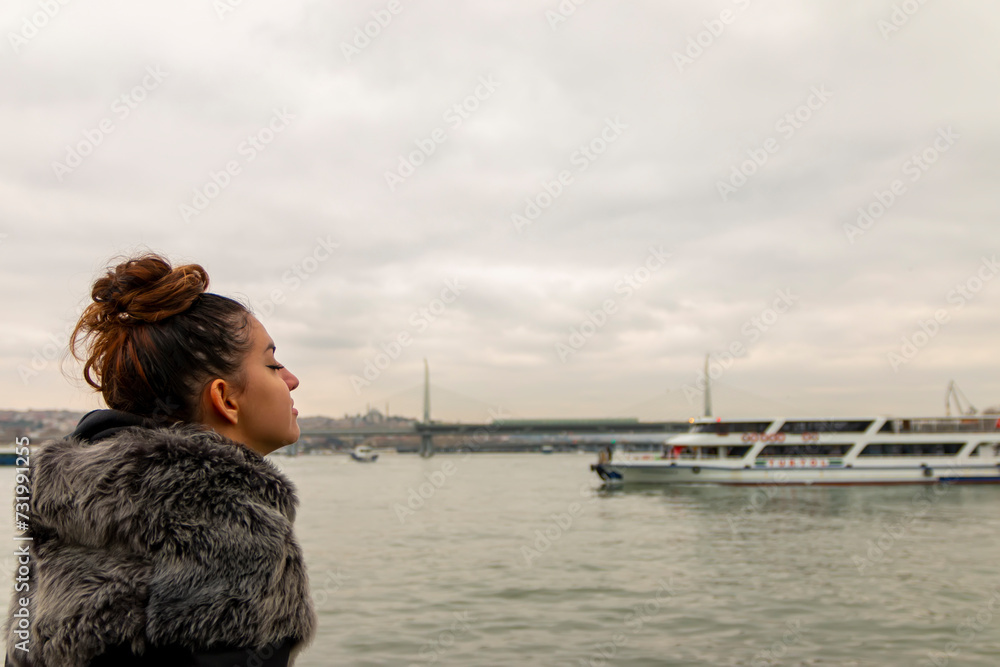 Young woman enjoying the view at the edge of the city and breathing in positivity. Meditation, releasing stress concept. Young woman enjoying the view at the edge of the city and breathing in positivity. Meditation, releasing stress concept.