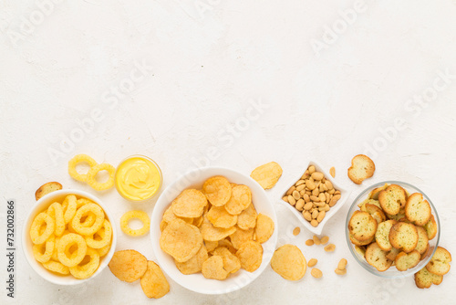 Obraz na plátně Various unhealthy snacks on concrete background, top view