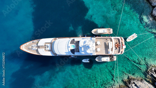 Aerial drone top down photo with copy space of luxury yacht anchored in tropical exotic island with crystal clear turquoise sea