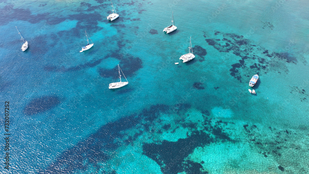 Aerial drone photo of sail boats anchored in paradise island of Paxos, Ionian sea, Greece Aerial drone photo of sail boats anchored in paradise island of Paxos, Ionian sea, Greece