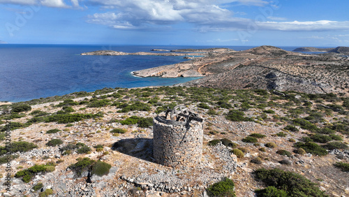 Aerial drone photo of old windmill built uphill in island of Schoinousa, small Cyclades, Greece