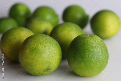 Orchard of fresh sweet limes, vibrant citrus fruits on white background. photo
