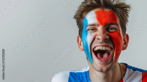France flag face paint, Close-up of a person's face, symbolizing patriotism or sports fandom.