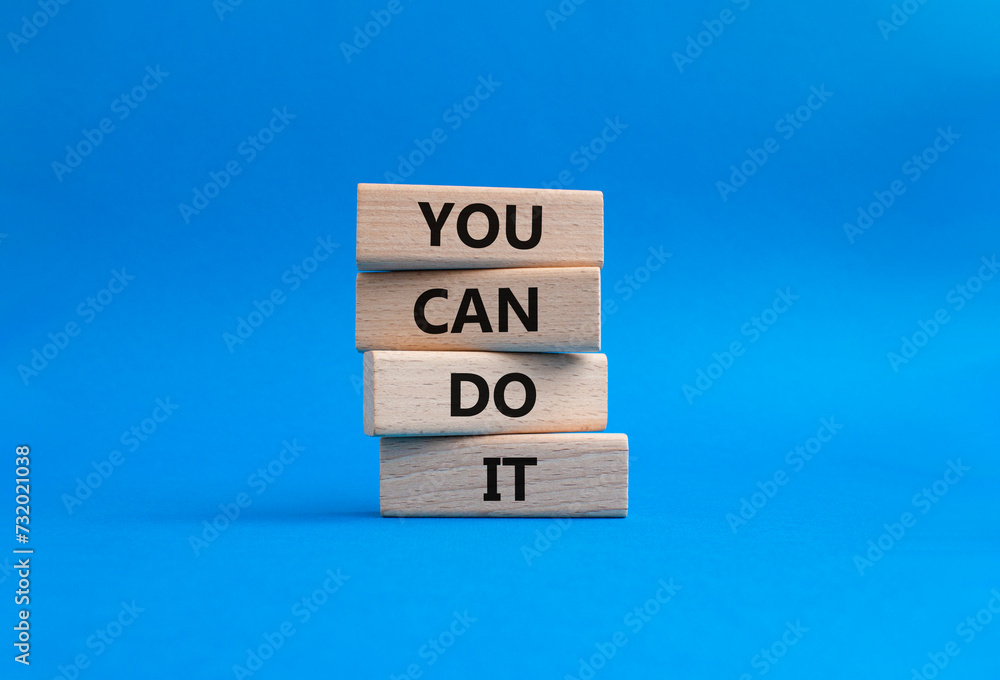 You can do it symbol. Concept words You can do it on wooden blocks. Beautiful blue background. Business and You can do it concept. Copy space. You can do it symbol. Concept words You can do it on wooden blocks. Beautiful blue background. Business and You can do it concept. Copy space.