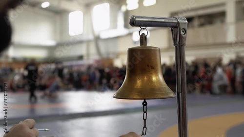 Striking a boxing gong bell before the start 