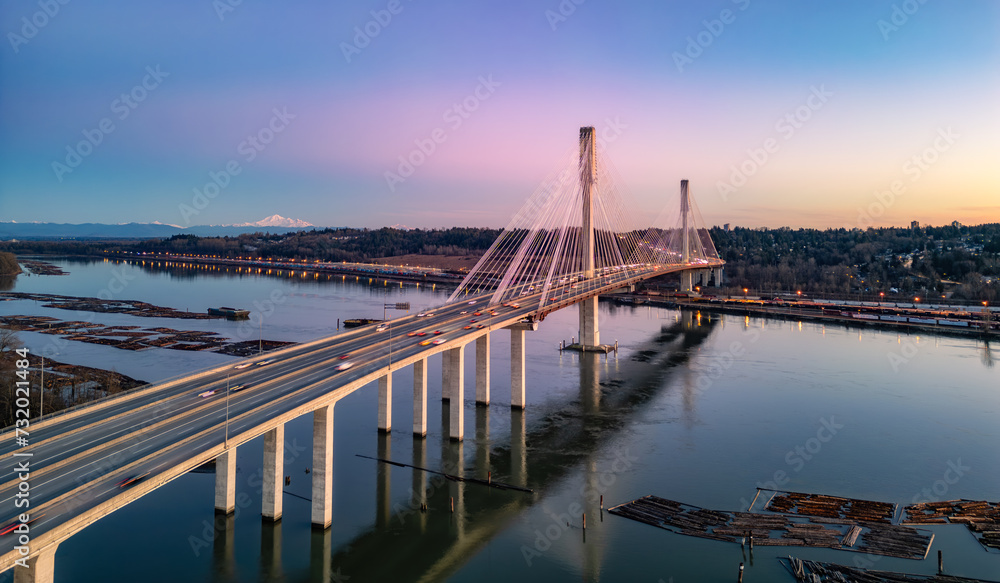 Fototapeta premium Port Mann Bridge across Fraser River. Sunset Sky.