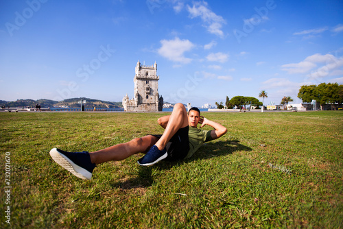Young man doing exercise near Belém Tower photo