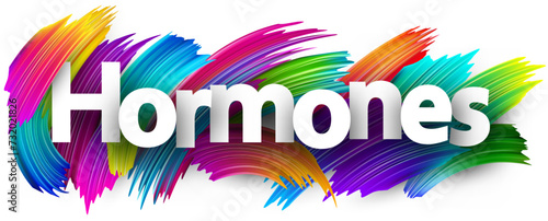Hormones paper word sign with colorful spectrum paint brush strokes over white.