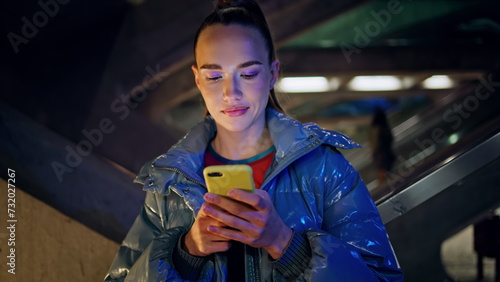 Photography Teenager surfing social media standing at urban building late evening close up