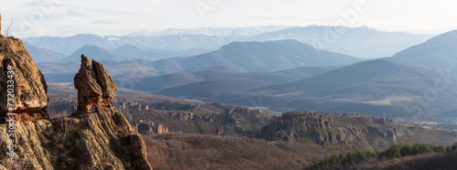 A scenic landscape of the Belogradchik Rocks and mountains in Bulgaria with impressive rock formations at golden hour in winter. Belogradchik, Bulgaria. Panorama