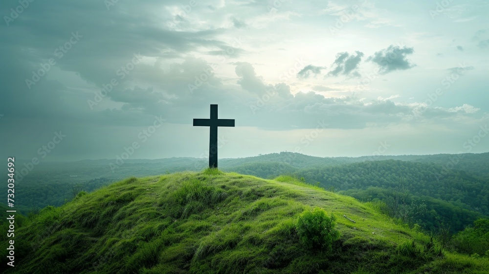 A Christian cross standing tall atop a lush green hill. large copyspace area A Christian cross standing tall atop a lush green hill. large copyspace area