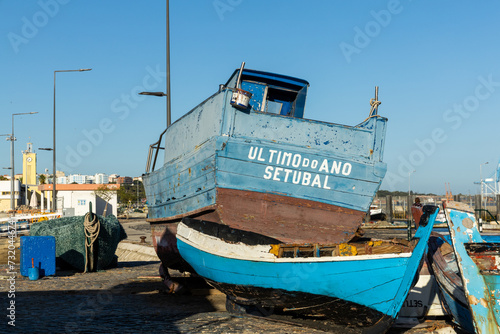 Setubal, Portugal. 11 August 2023. Small traditional fishing boat on the quay for repairs and painting. Name of the boat “Ultimo do Ano Setúbal” in English “Last of the Year Setúbal”