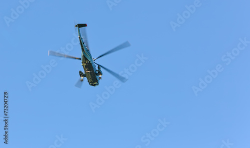 military helicopters flying in blue sky (air force style chopper with large blades) two copters (presidential transport over hudson river in new york city)