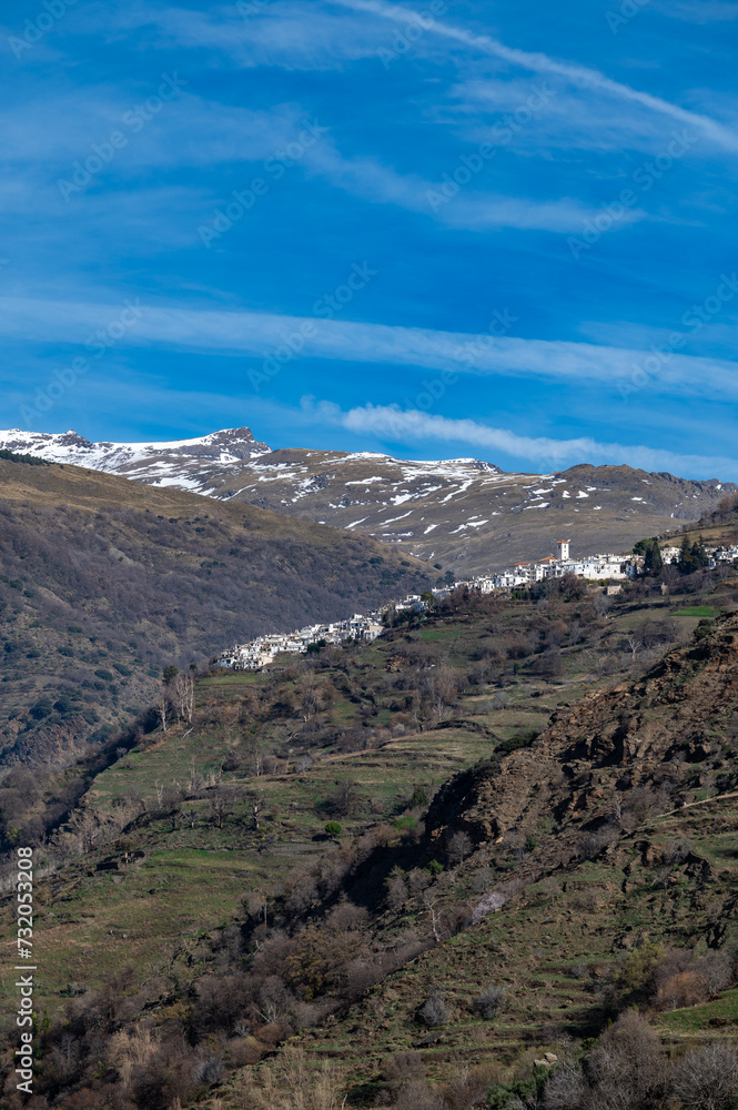 Vertical view of the picturesque Granada village of Capileira (1436 m altitude) in the Alpujarra on a sunny winter morning